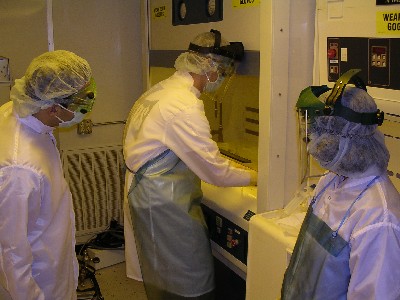 Students performing wet chemistry work in the class 1000 clean room. 