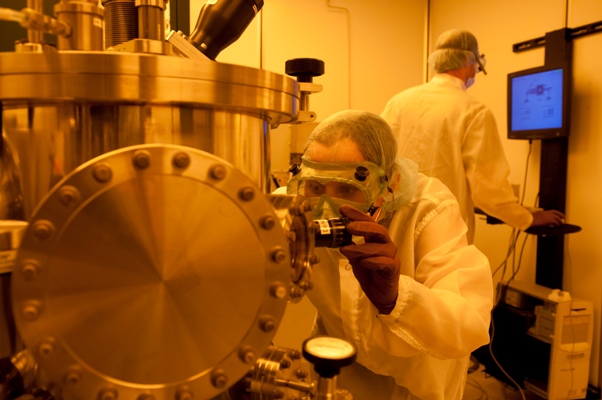A student operates the RF/DC sputtering system. 