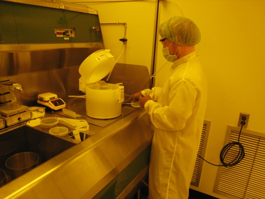 A graduate student prepares a wafer for photoresist application. 