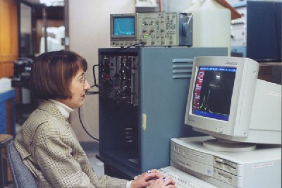 Holly Gersch tests a self-biased GaAs neutron detector in a nuclear reactor beam port. 