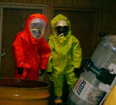 HAZMAT crew returning from investigating an unknown leaking drum.  They are wearing a completely sealed Level A suit.