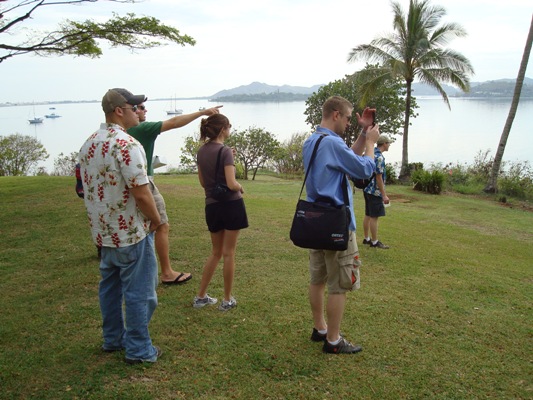 (From left,) Steve Bellinger, tour guide Stan McRay, a tourist, Mark Harrison and Walter McNeil look over a bay on O'ahu. 