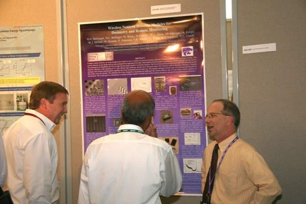 Prof. McGregor discussing the details of his poster regarding compact wireless modules for neutron detection and gamma ray spectroscopy. 