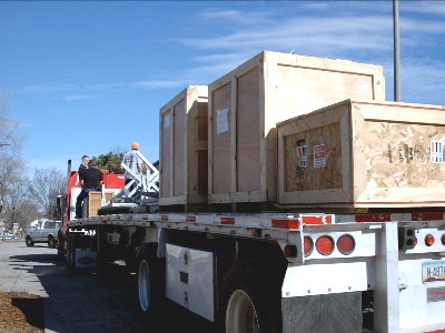 The flatbed truck was loaded from front to back with the furnaces, materials, and equipment. 