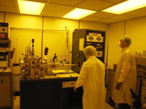 Students operate the RF/DC sputtering system in the vacuum process bay. 